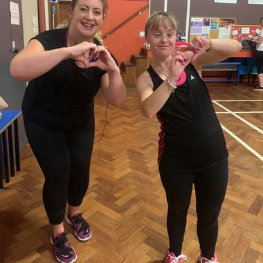 Empower participatns Abbey and Dee working out in community room