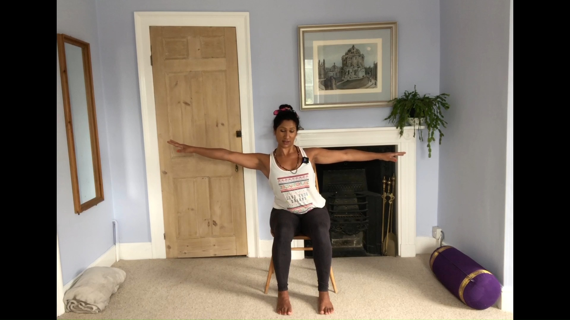 Basma Gale, Adaptive Yoga LIVE coach, doing a seated yoga exercise