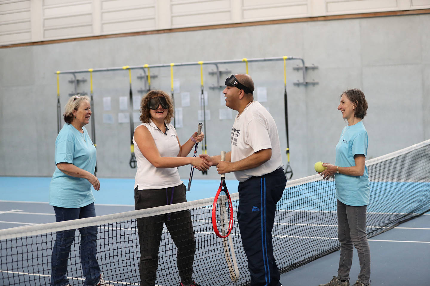 LTA Open Court visually impaired tennis game in sports hall.
