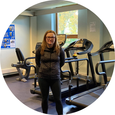 Heather smiling to camera in one of Seashell Trust's gym facilities. 