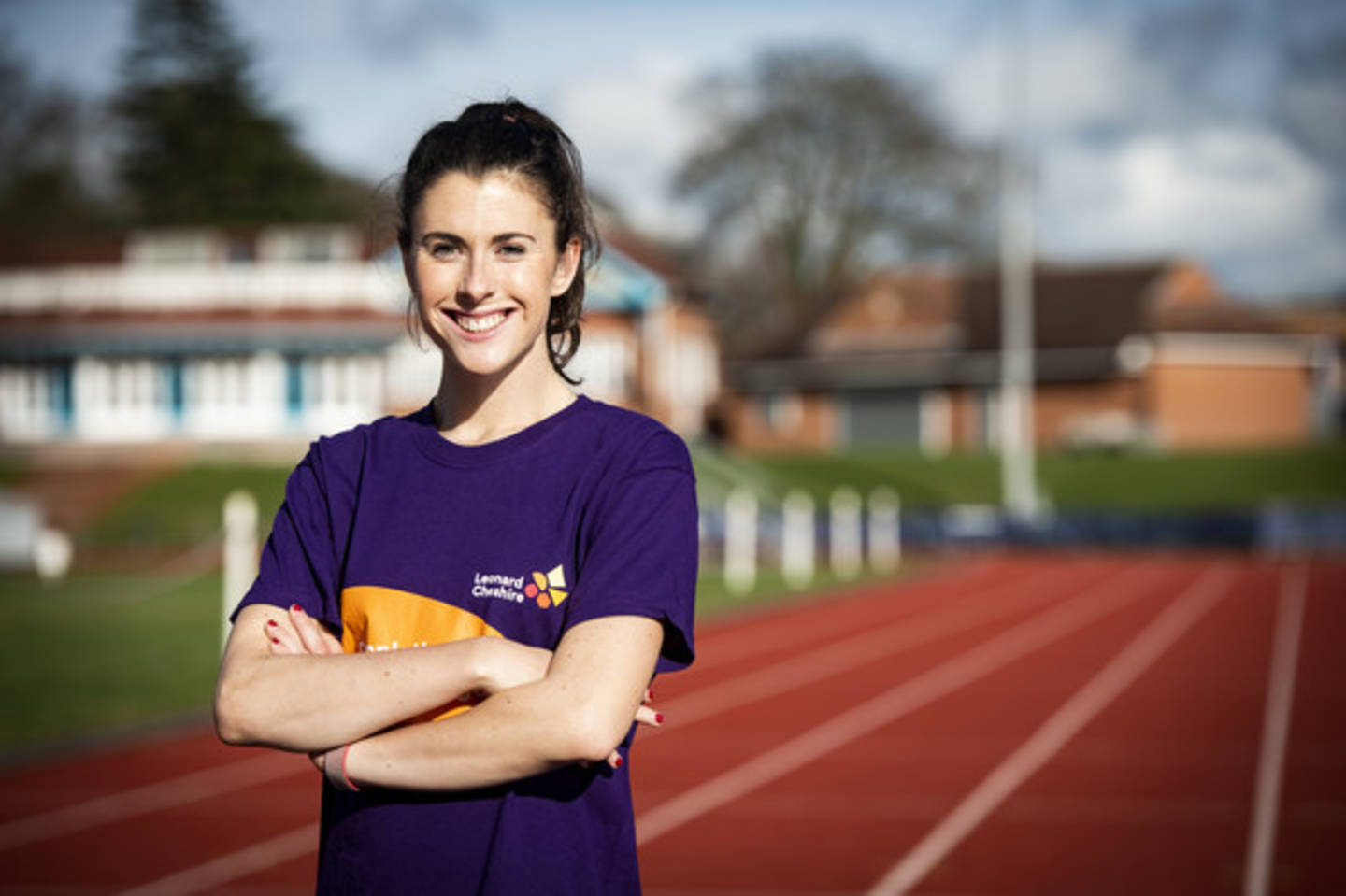 Olivia Breen smiling to camera standing on running track.