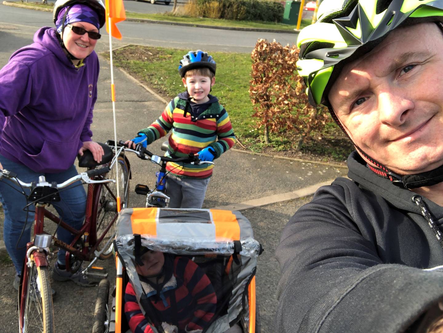Mark, his wife and children using adapted bikes