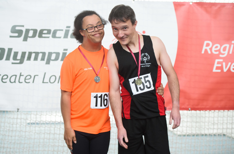 Special Olympics GB athletes smiling with their medals