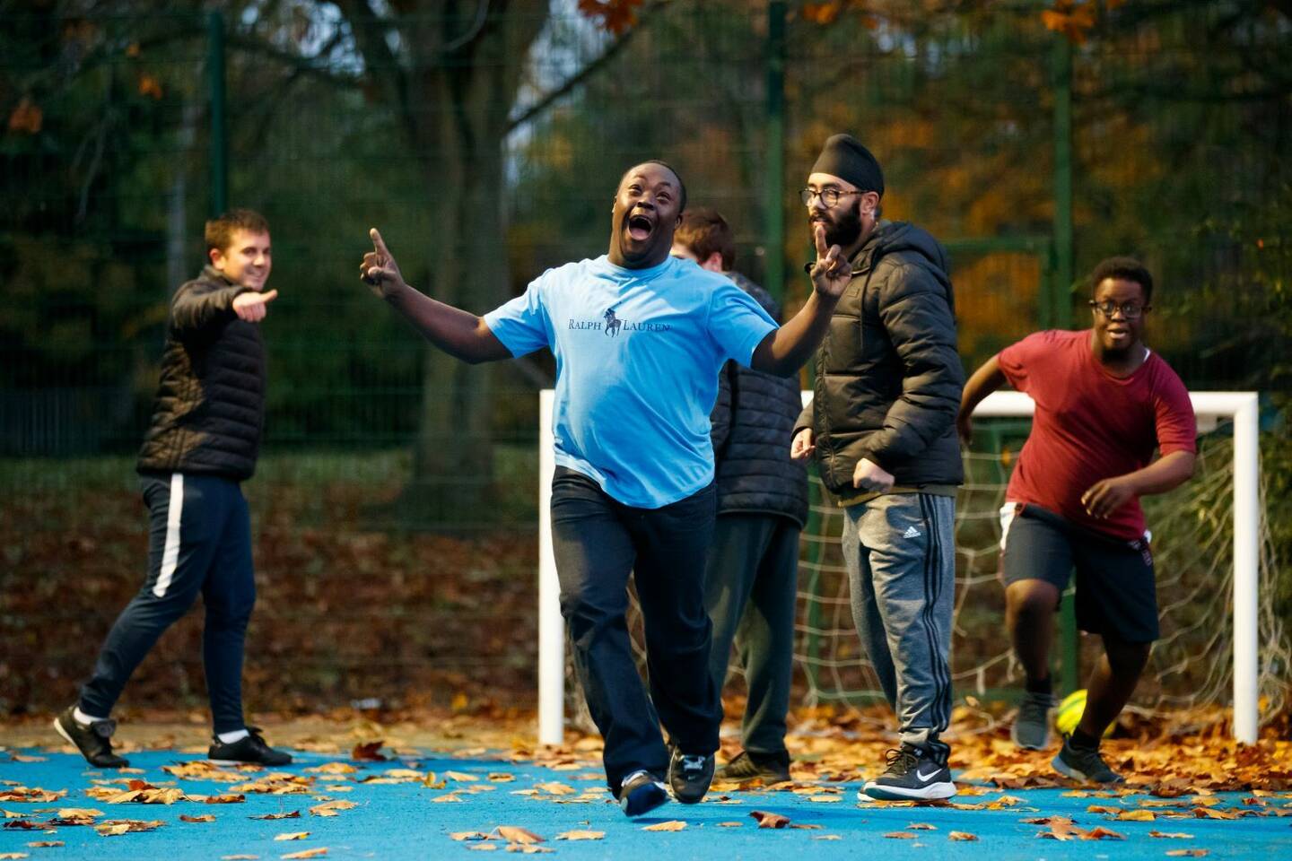A group of disabled people enjoying themselves being active outside. 