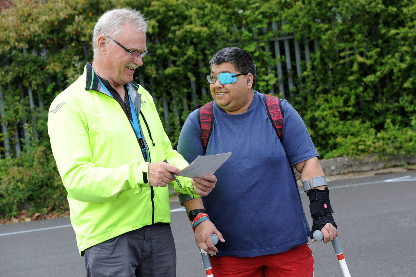 Volunteer supporting man with sight loss to be physically active