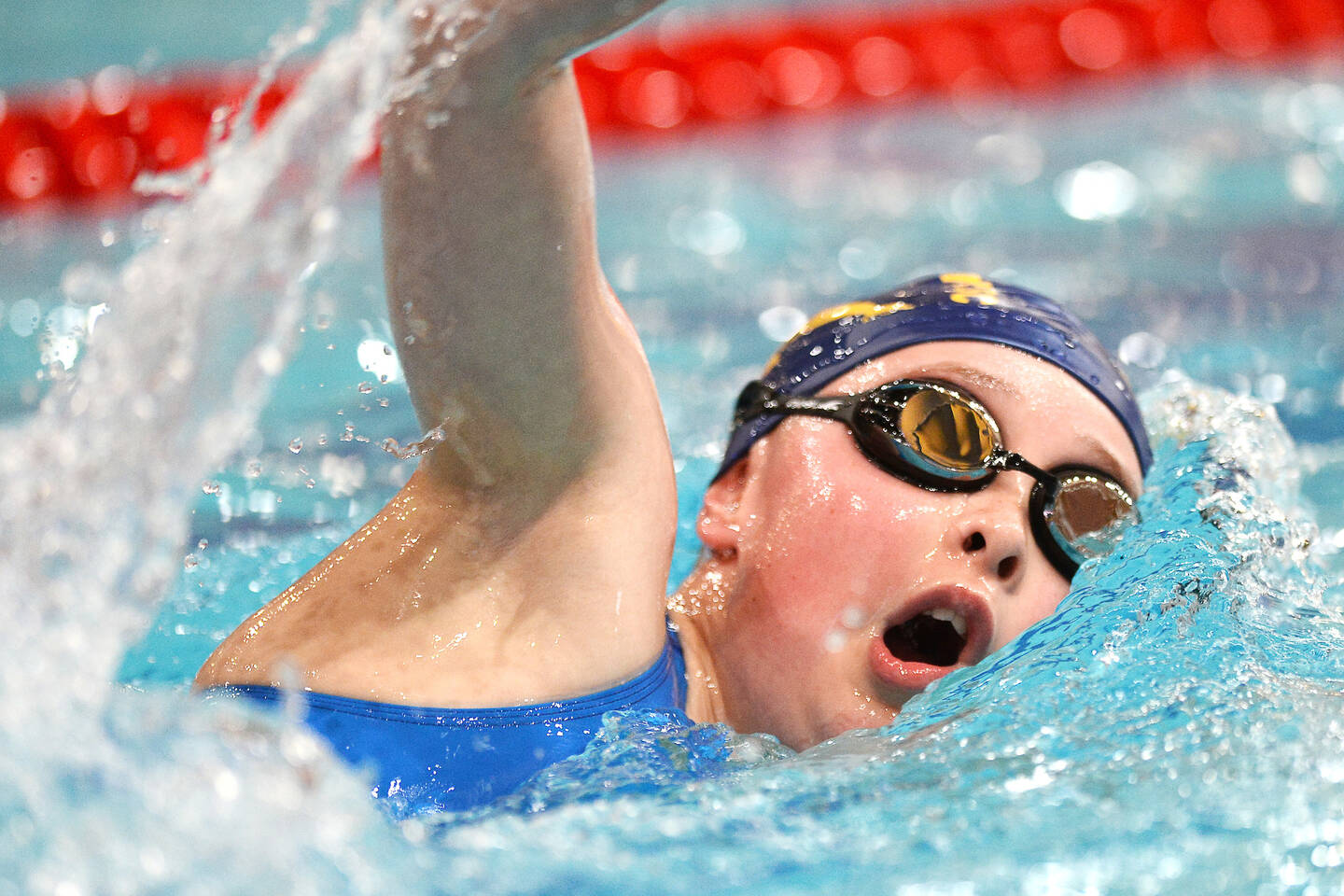 Young disabled person swimming in a race at swimming event