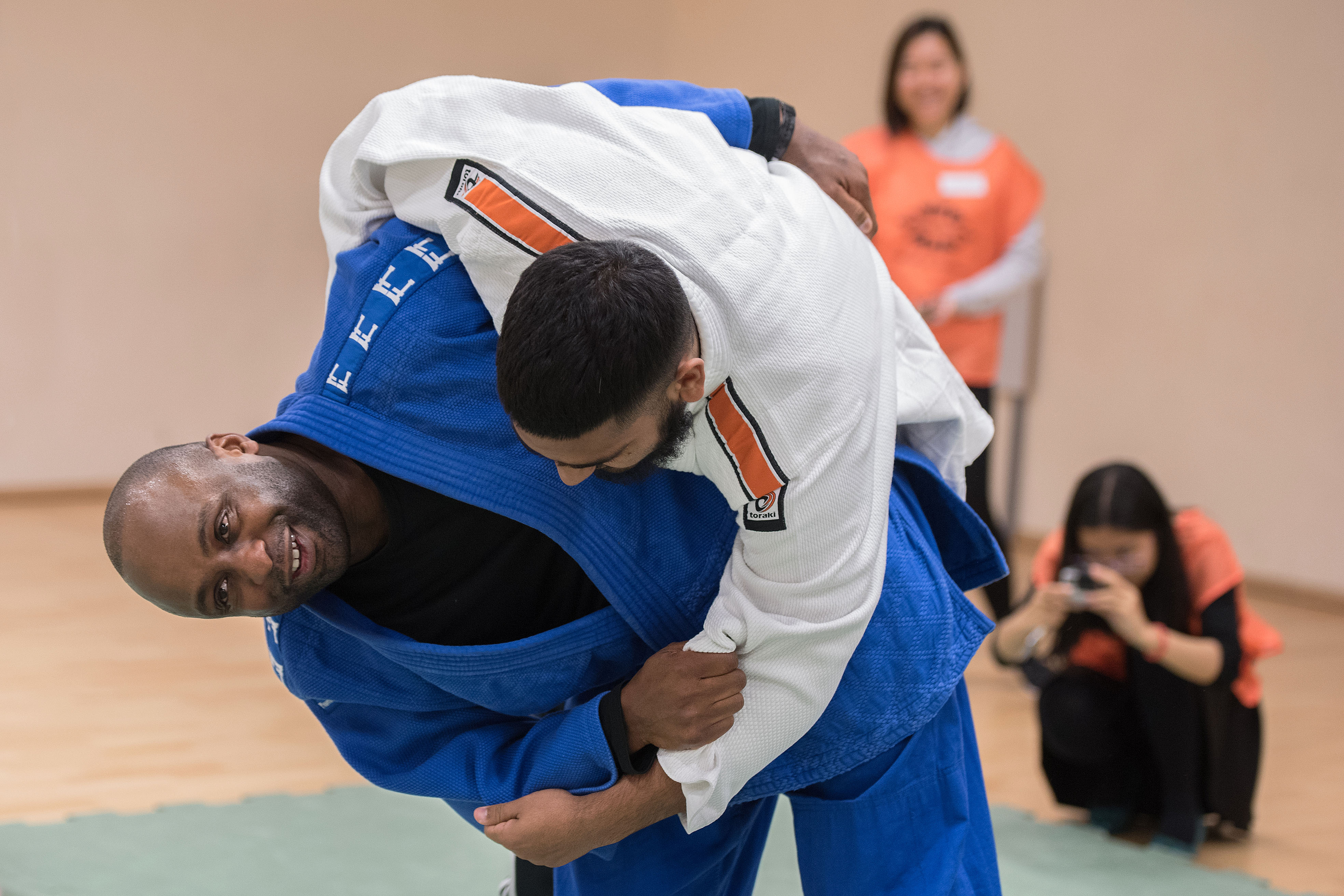 Two men in judo session, working to throw each other to the ground
