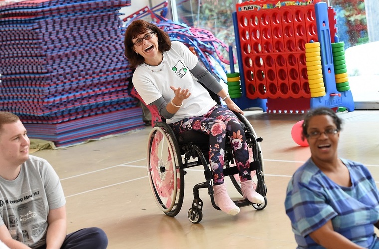 Amanda Worne playing sitting volleyball in inclusive sport session. 