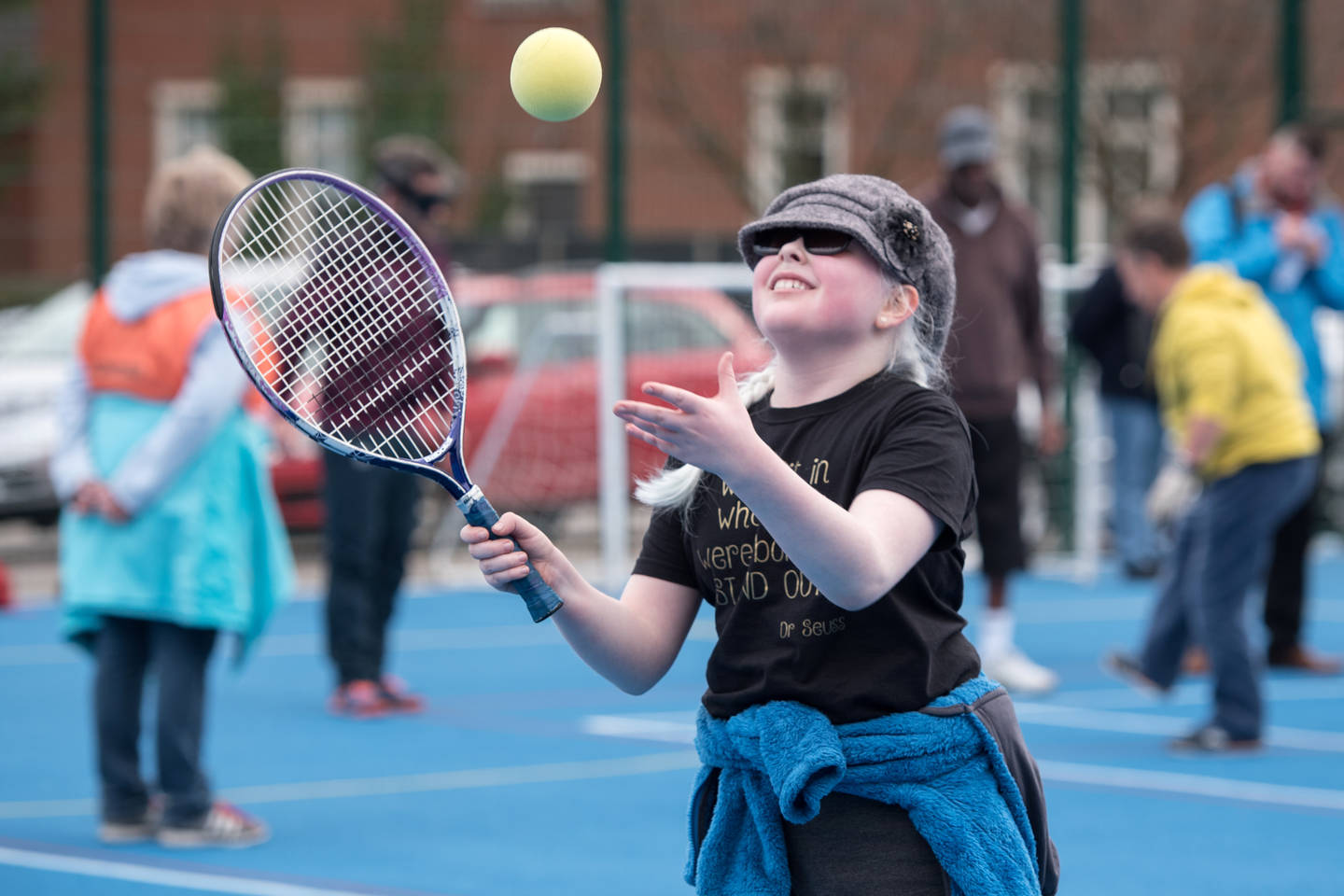 Girl with visual impairment playing tennis