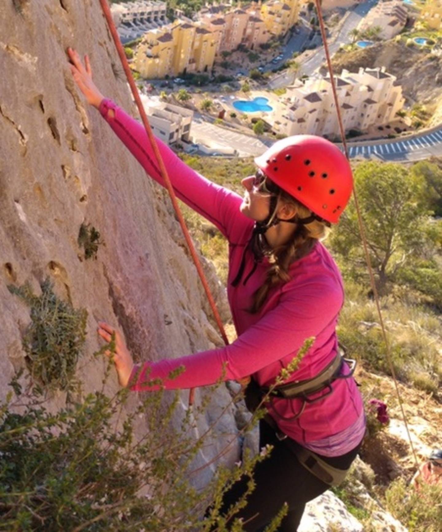 Emily climbing a rock. 