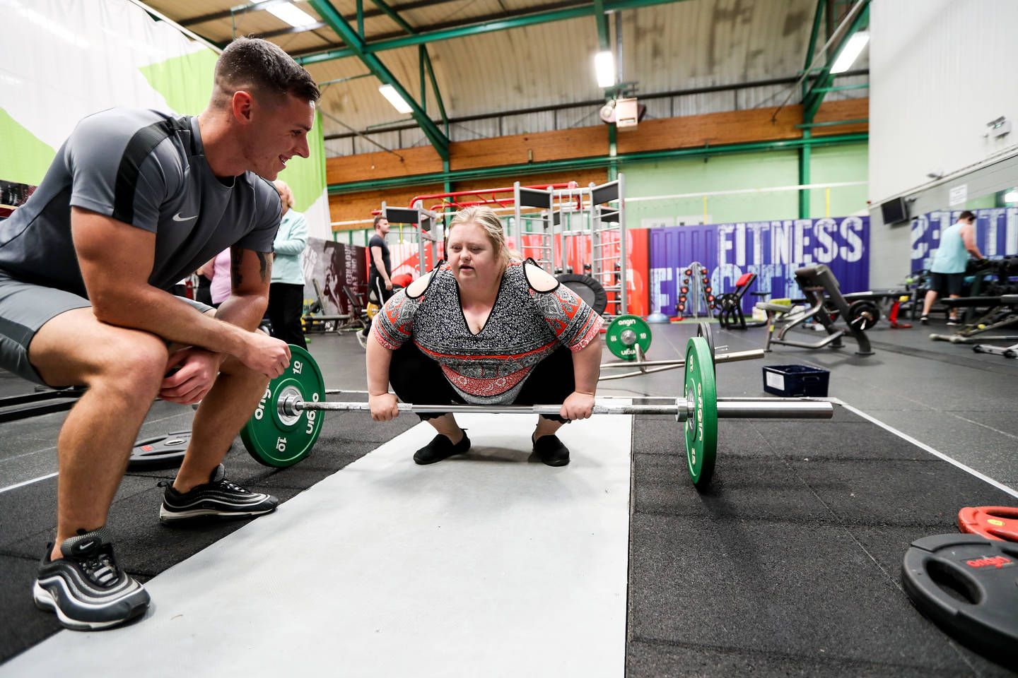 Ben encouraging client on rowing machine. 