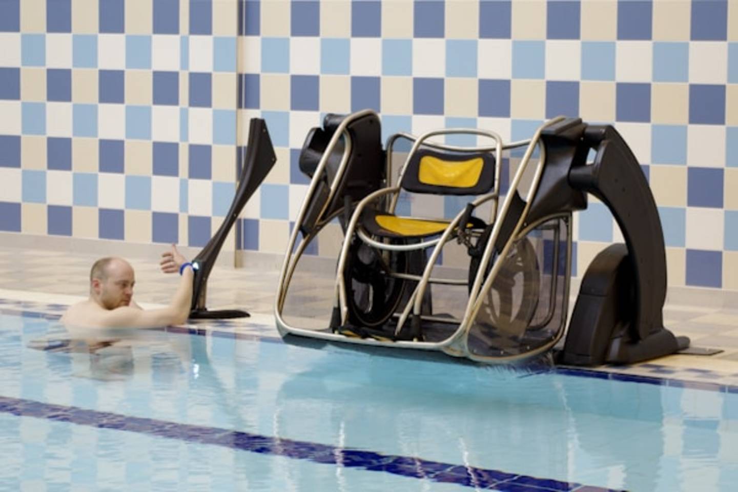 A man using a PoolPod from the swimming pool