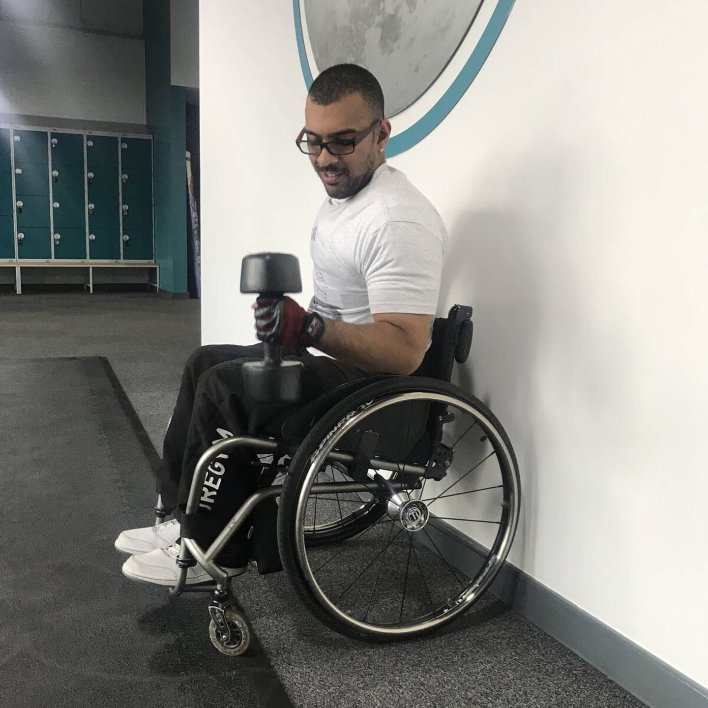Rob doing a bicep curl with a weight in the gym.