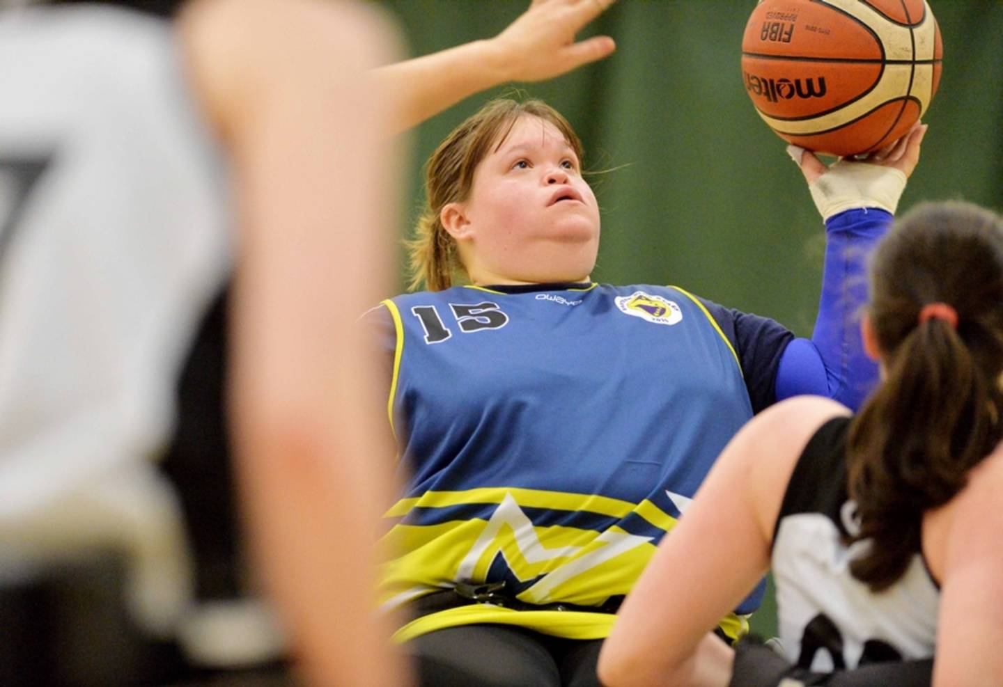 Close up photo of players during game of wheelchair basketball 