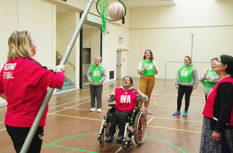 Wheelchair user shoots goal in inclusive netball session
