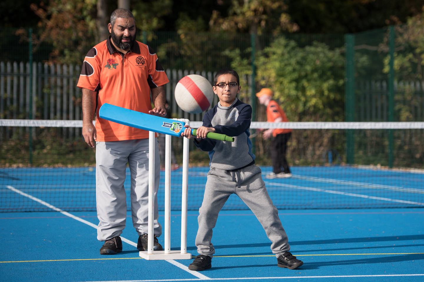 Young boy with visual impairment playing cricket