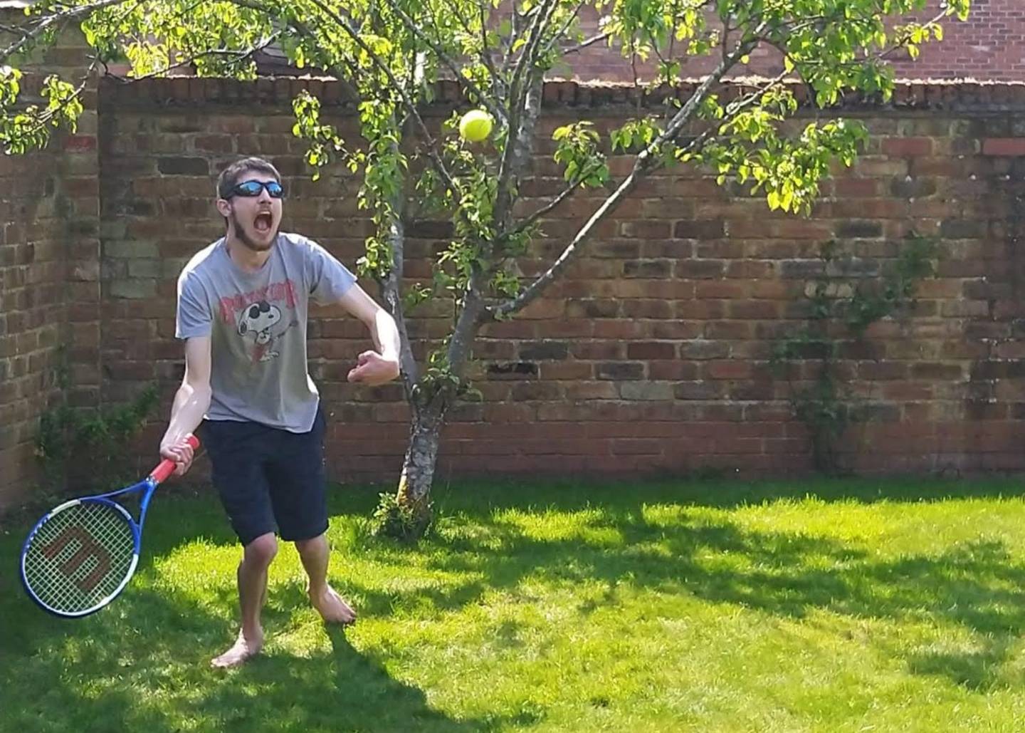 George playing tennis in garden