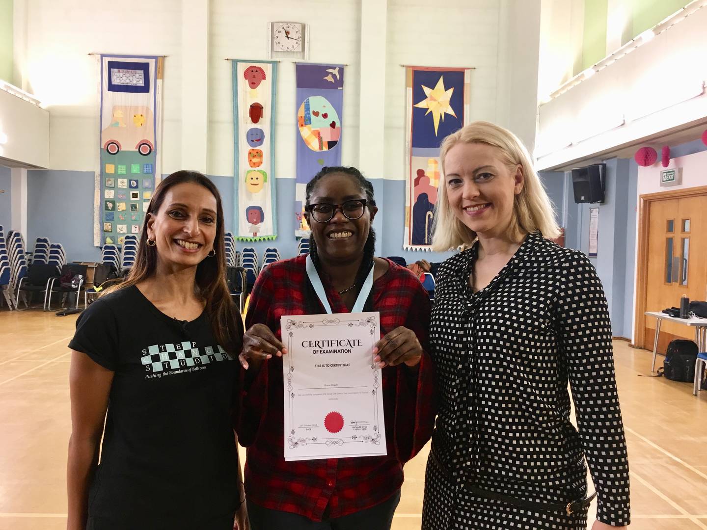 Grace smiling to camera dance certificate in hand. Rashmi, CEO of Step Change Studios is also standing beside her smiling to camera.