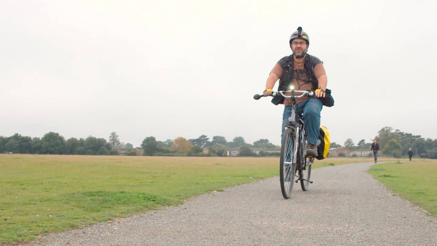 Wolf cycling in a park.