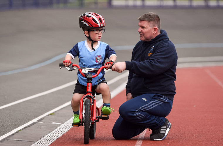 Young boy taking part in cycling activity at the National Dwarf Games