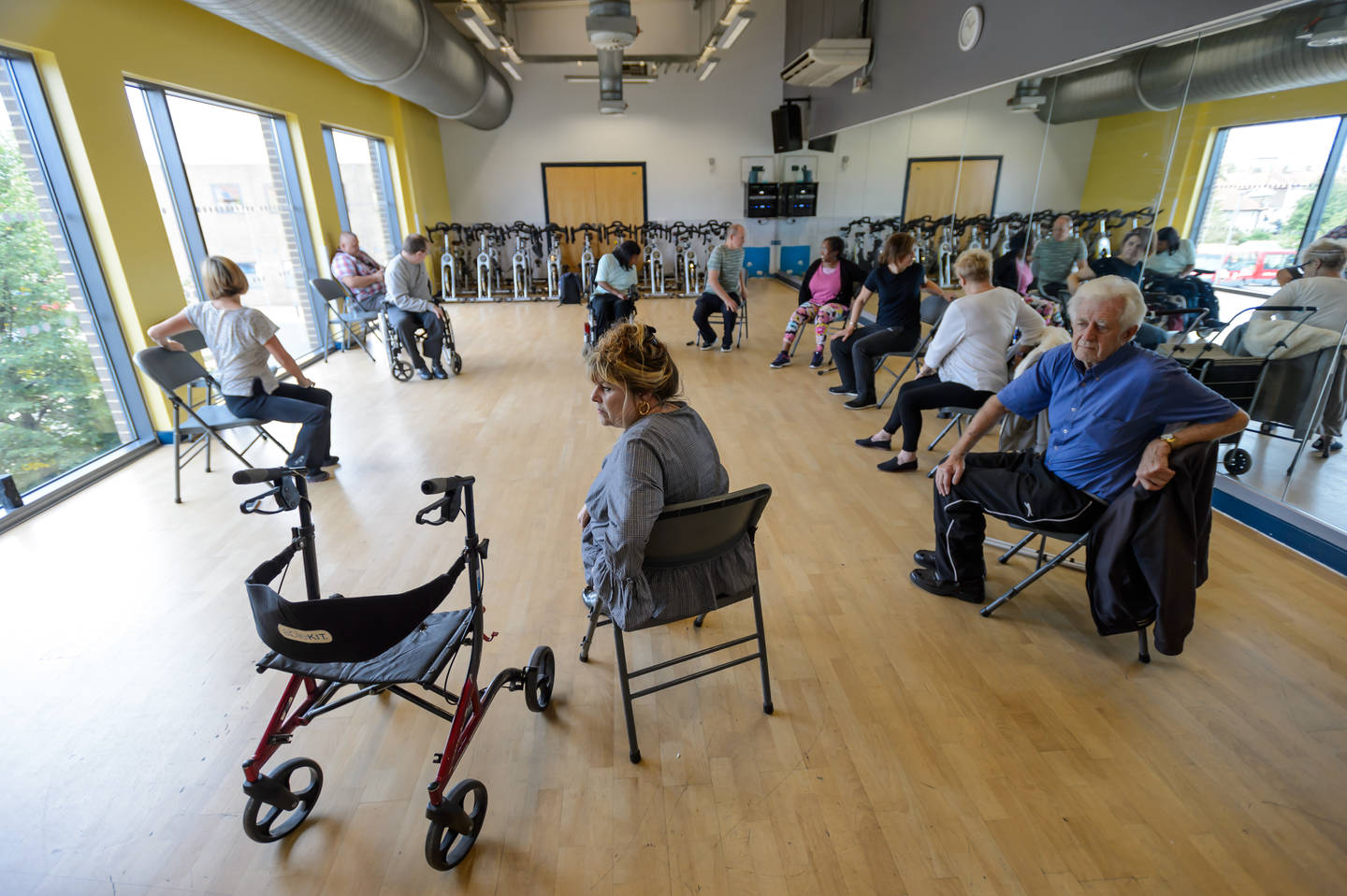 Older disabled and non-disabled adults taking part in seated exercise class 