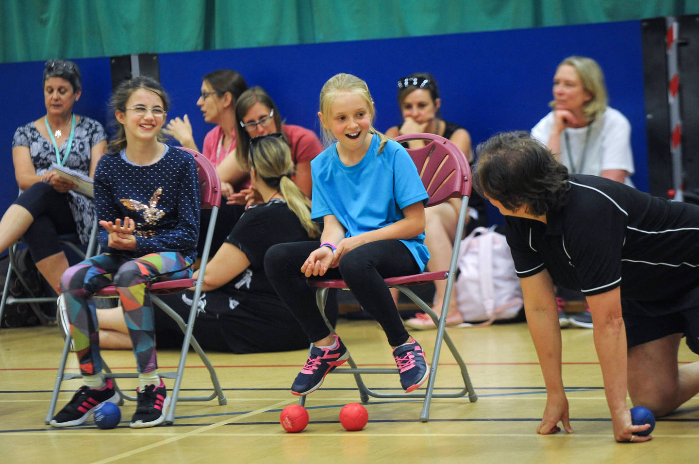 Two girls with visual impairments having fun playing boccia