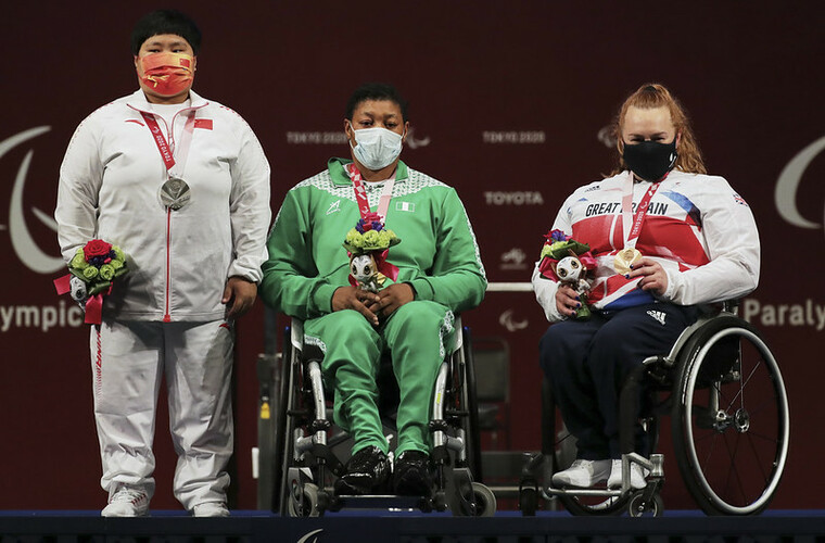 Louise Sudgen on podium after winning powerlifting bronze medal at Tokyo 2020