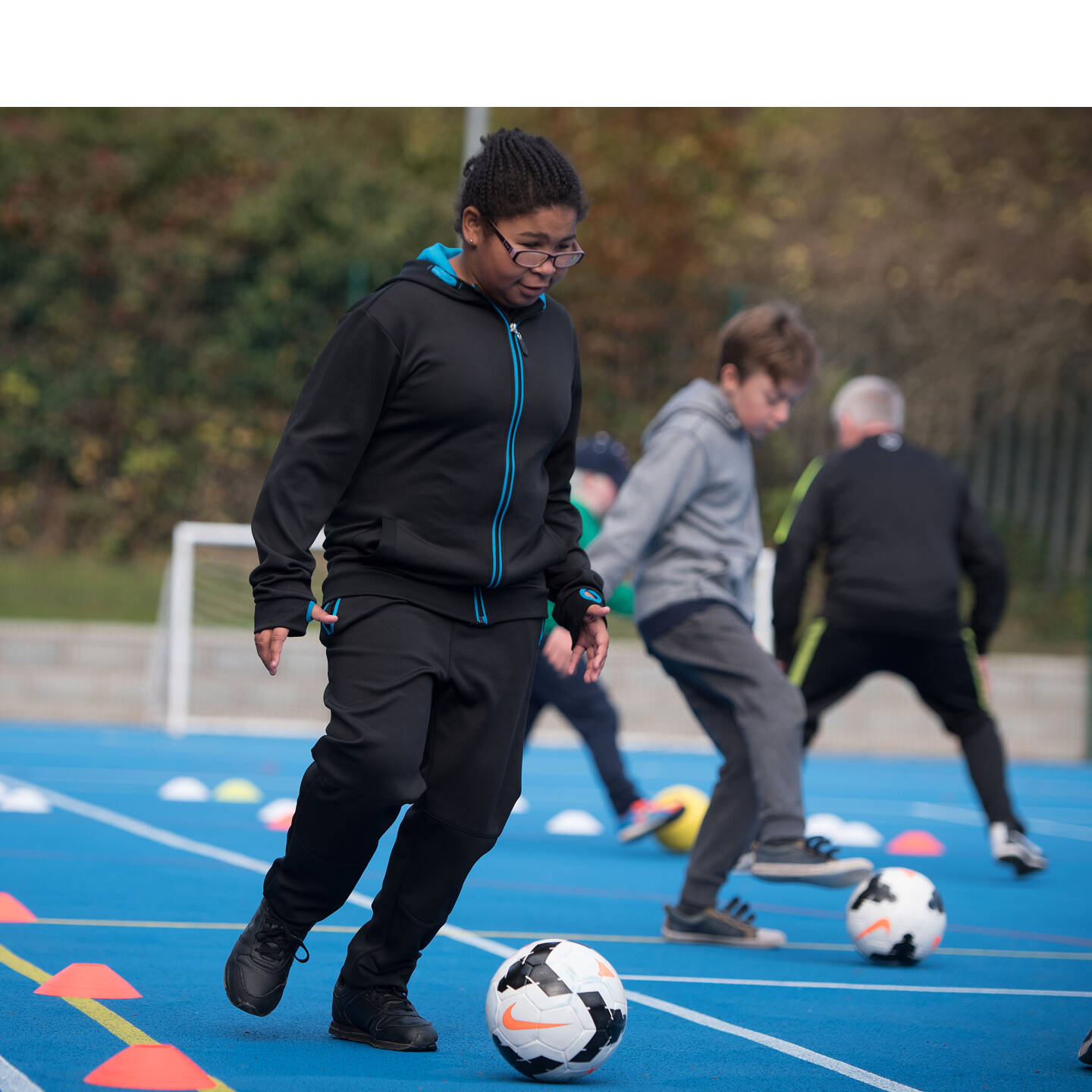 Boy with a visual impairment playing football. Photo credit: British Blind Sport