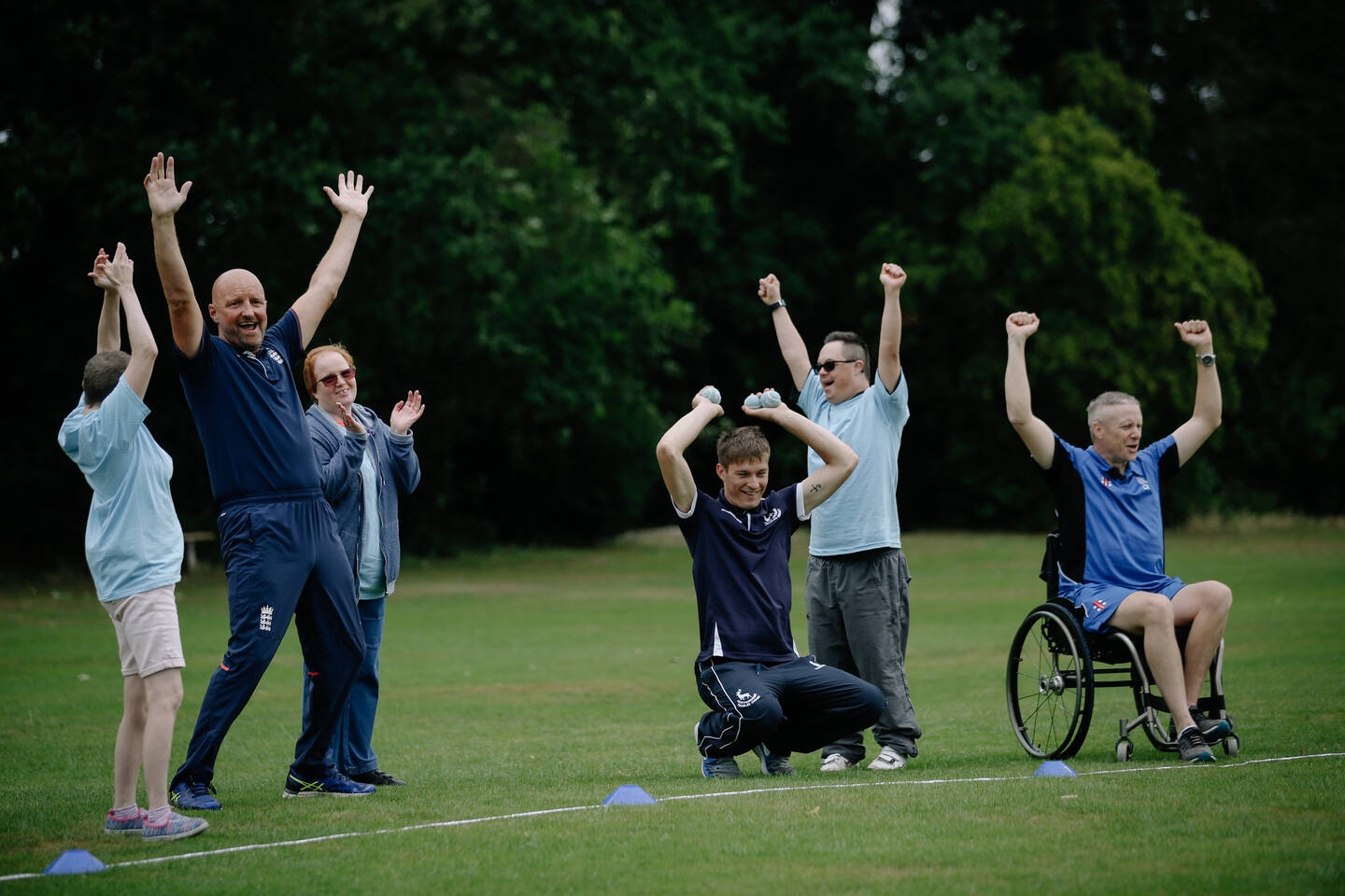 Group of disabled people having fun playing cricket based games and skills 