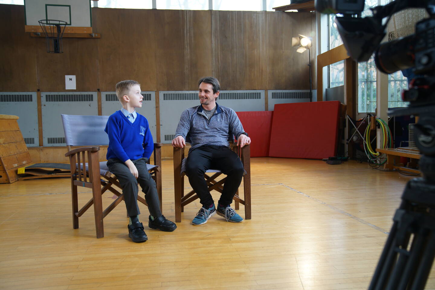 Deputy Principal David Swanston sitting next to one of his students from St Vincent's School.