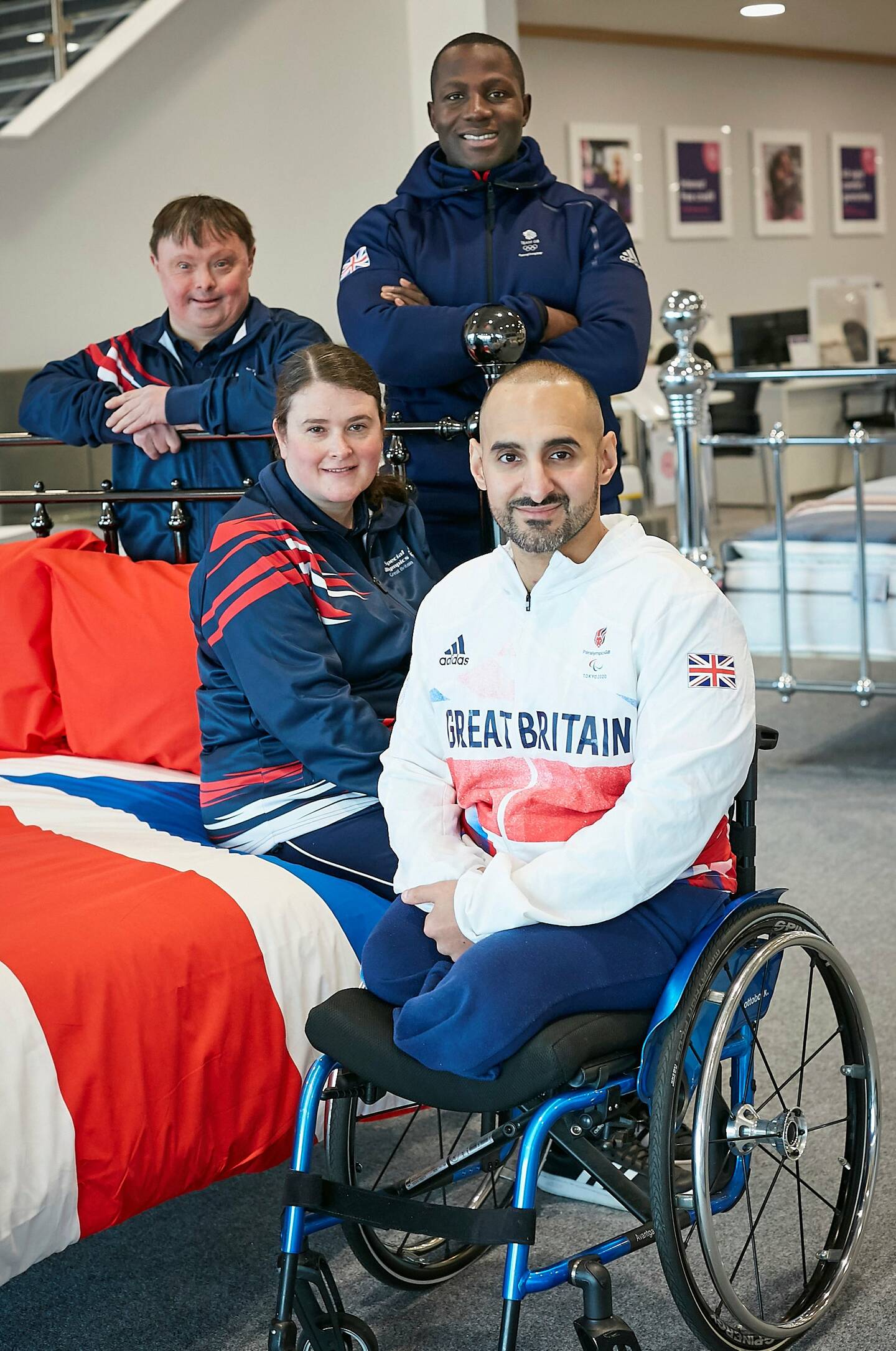 SOGB, British Paralympics Association, British Olympic Association athletes next to a Dreams bed.