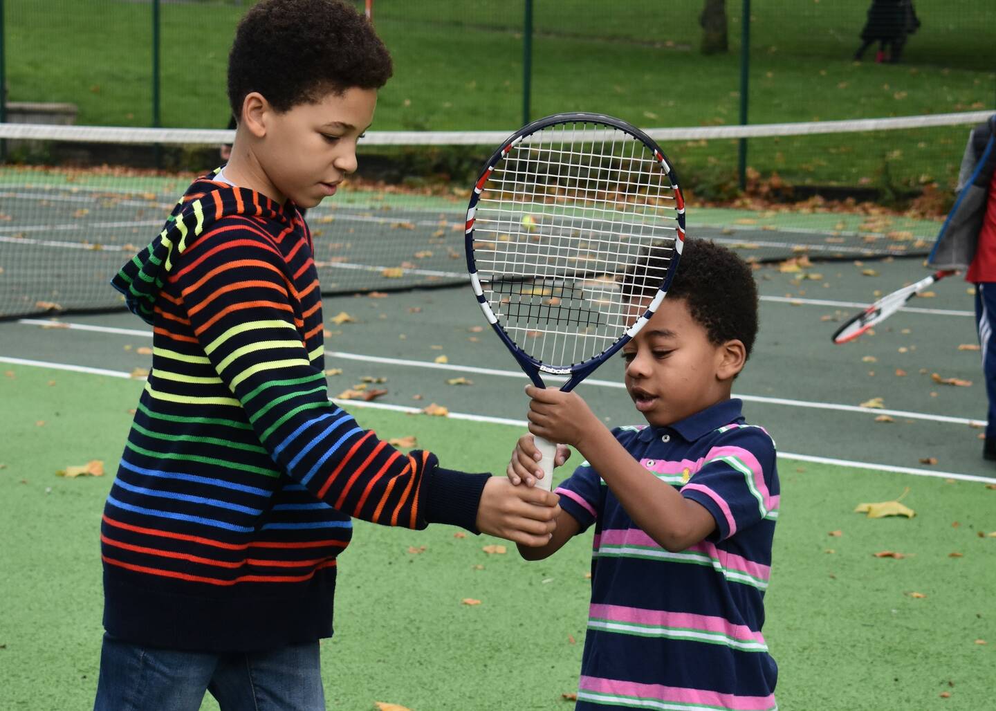 Two boys playing tennis