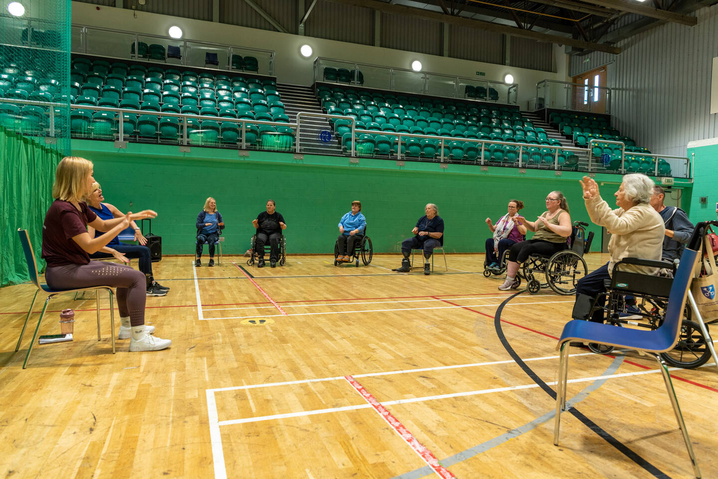 People of all ages sat in a circle taking part in the Healthy Living Day activities. 