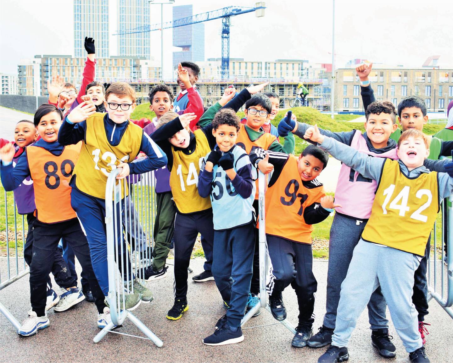 Group of children smiling and waving to camera at an Access Sport BMX event