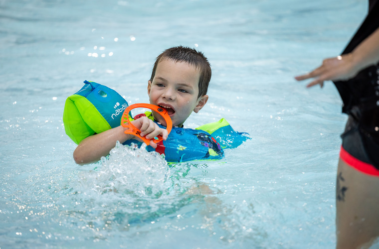 Active Tameside activity featuring a young swimmer in the pool.