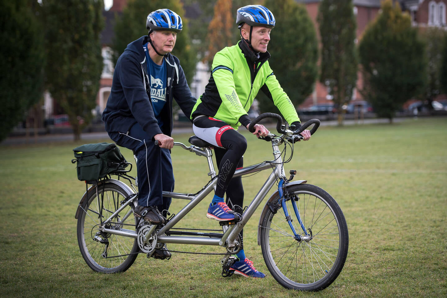 Visually impaired man cycling on a tandem with a guide 
