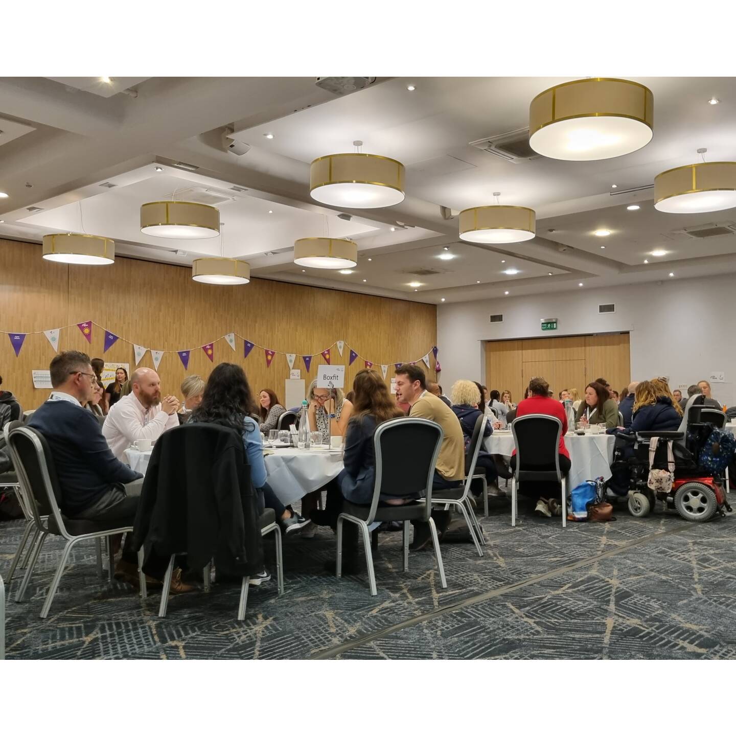 Groups of people networking at the Get Out Get Active conference.