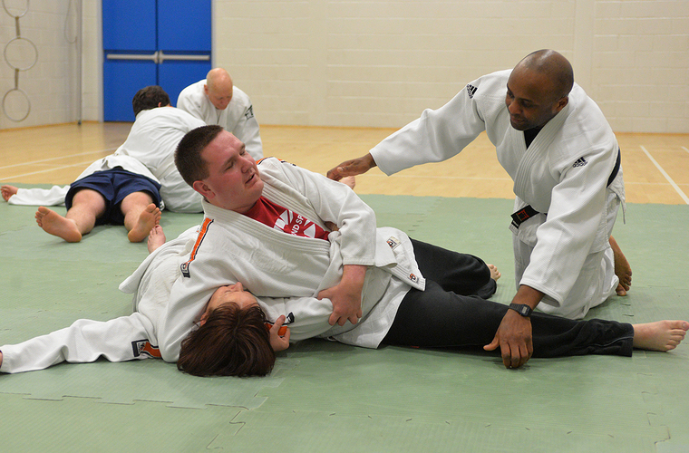 Two visually impaired people taking part in a judo taster session 