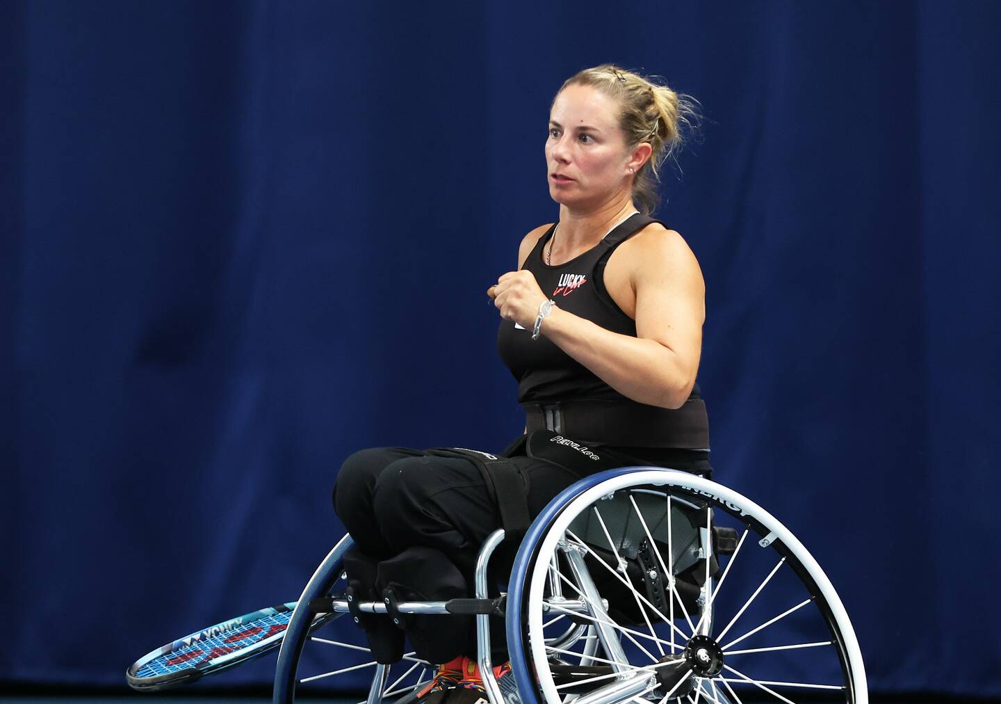 Lucy Shuker holds one fist up in celebration.