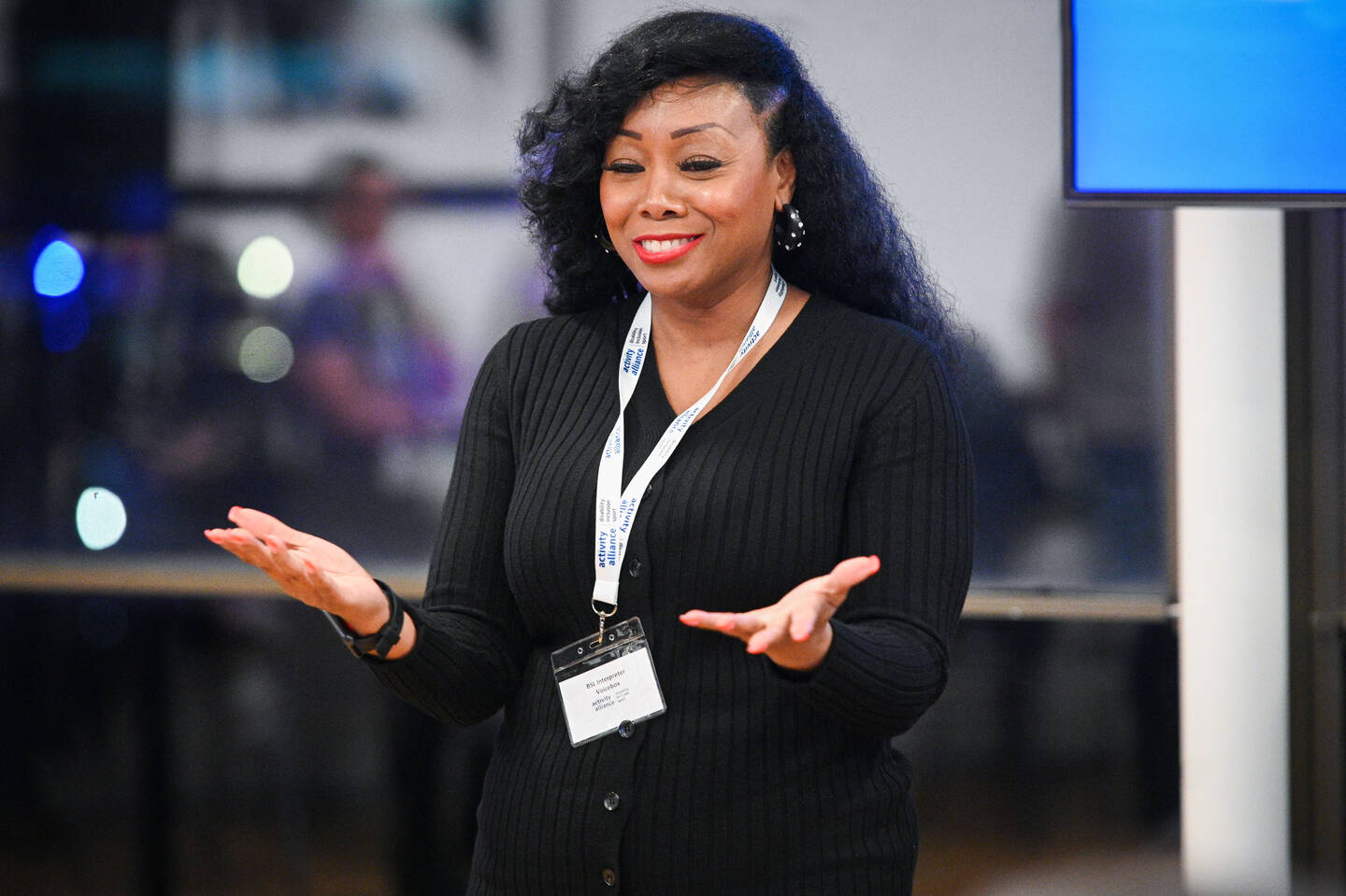 Woman using sign language at an event to interpret for the speaker