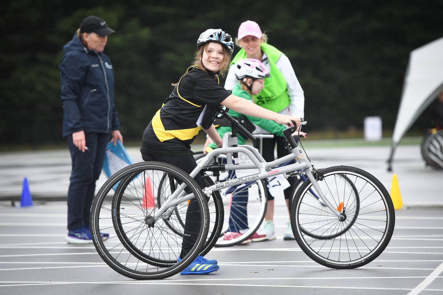 A young person on a track using a frame runner.