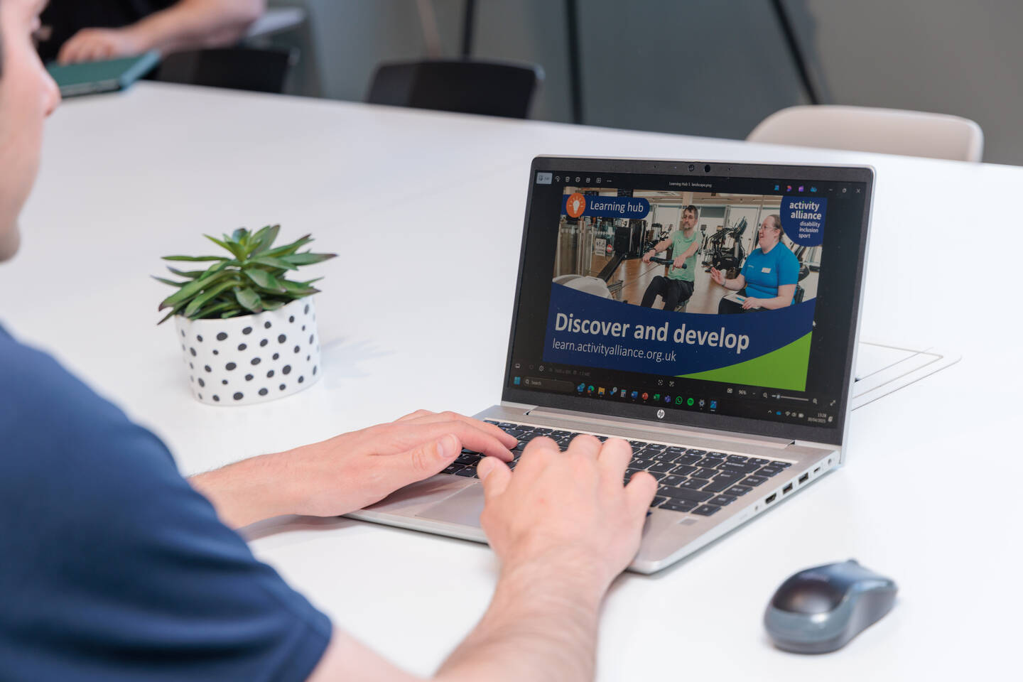 A laptop screen with a slide that says Discover and Develop.