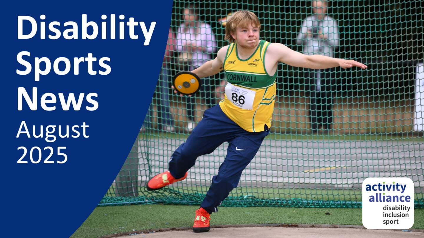 Disability Sports News August 2025. A young disabled man takes part in a discus competition. He hold the discus and gets ready to throw. There is a net behind him.