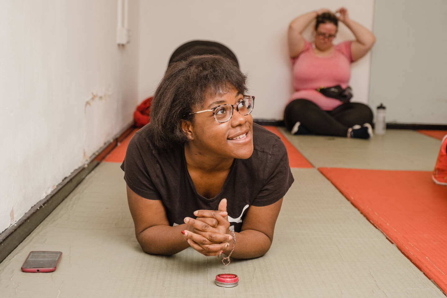Young black disabled woman stretching on the floor in plank position