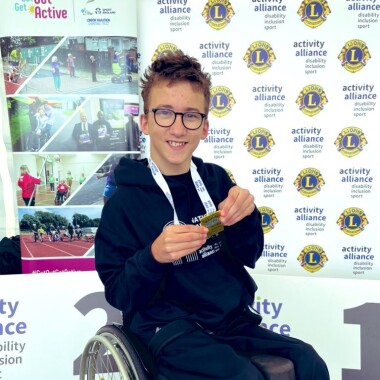Tristan posing with his medal in 2024