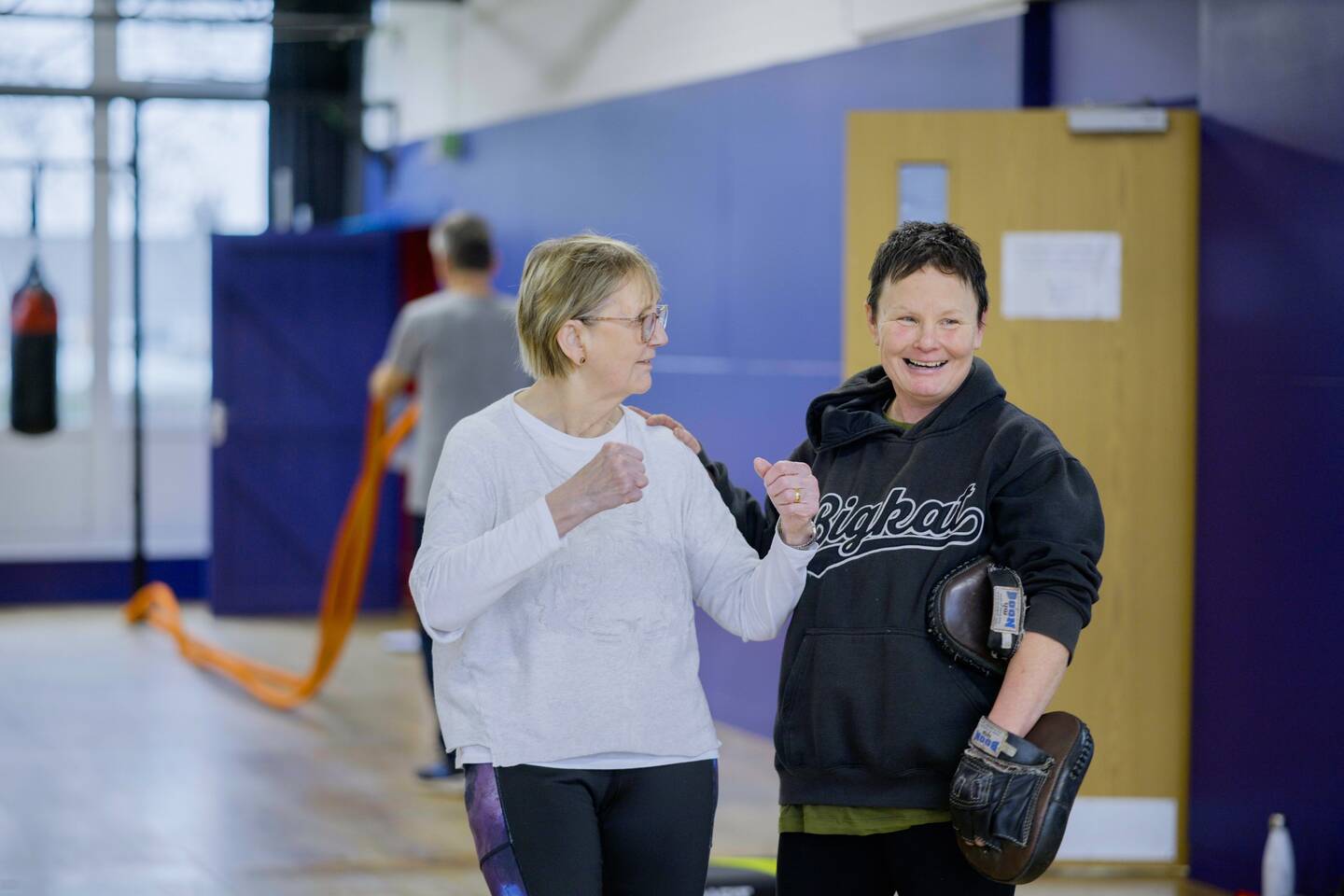 Two ladies getting ready for an inclusive boxing session at a leisure centre