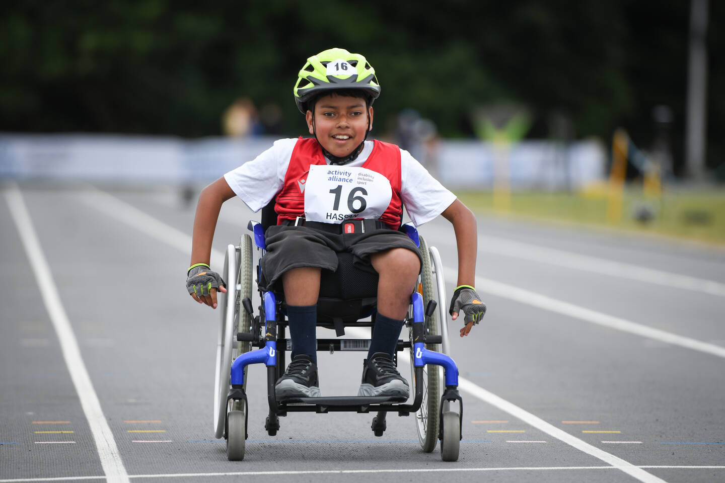 A young boy using a wheelchair in a wheelchair race at the National Junior Para Athletics Championships 2025.
