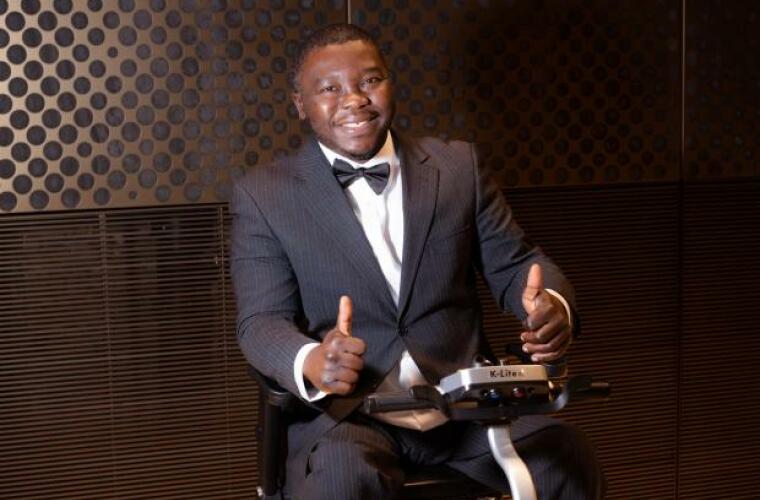 Paul Fosu on a motorised scooter