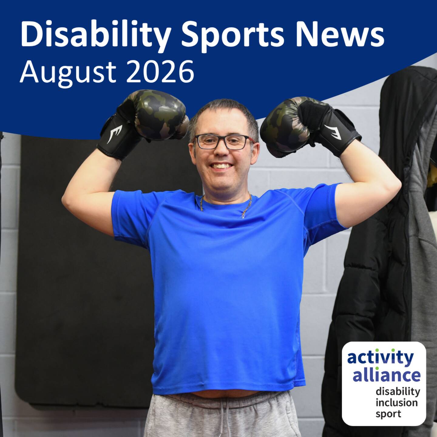 Disability Sports News August 2026. Photograph of a man wearing boxing gloves and holding his fists in the air, smiling at the camera.