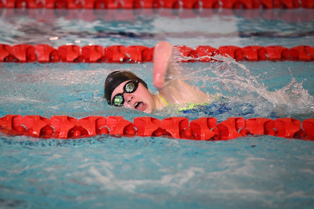 Young para swimming in action swimming during a race